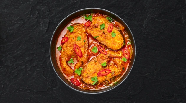 Taste our spicy garnished fish curry, the best Indian food Singapore offers for a truly authentic experience.